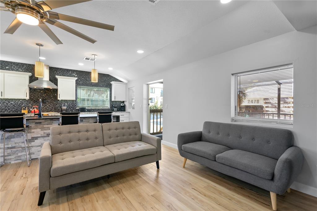 2476 North Beach Road Englewood, FL 34223 - Photo 21 of 58 a living room with furniture white walls and a fireplace