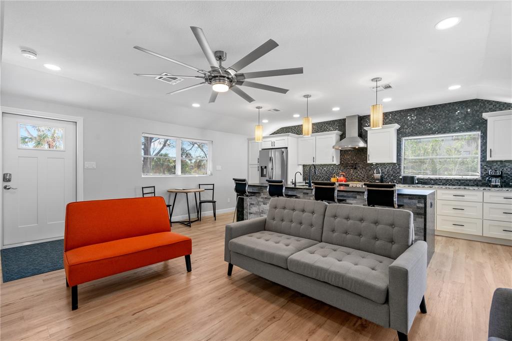 2476 North Beach Road Englewood, FL 34223 - Photo 22 of 58 a living room with furniture kitchen view and a flat screen tv