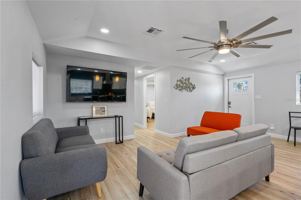 2476 North Beach Road Englewood, FL 34223 - Photo 24 of 58 a living room with furniture and a flat screen tv