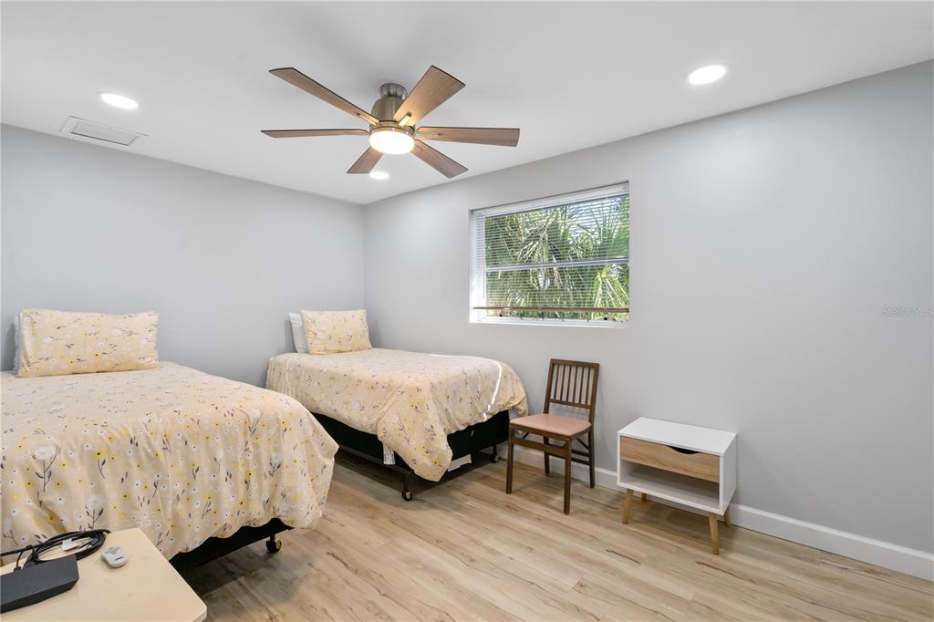 2476 North Beach Road Englewood, FL 34223 - Photo 27 of 58 a bedroom with two beds and a window