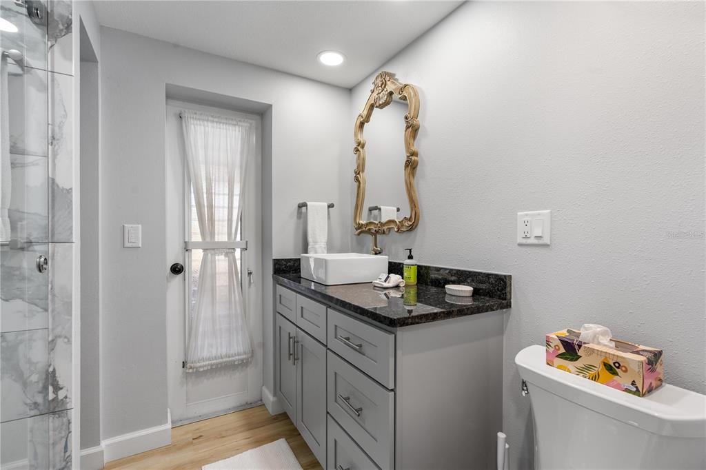 2476 North Beach Road Englewood, FL 34223 - Photo 31 of 58 a bathroom with a sink vanity and a mirror