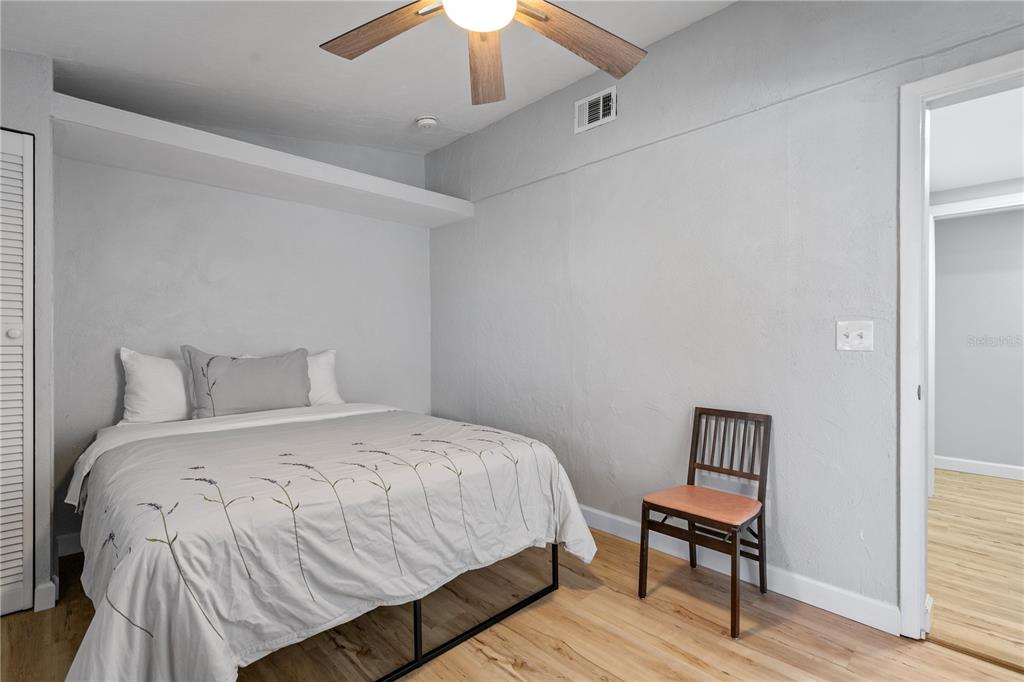 2476 North Beach Road Englewood, FL 34223 - Photo 35 of 58 a bedroom with a bed and wooden floor