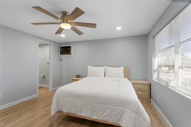 a bathroom with a granite countertop sink a mirror and a shower