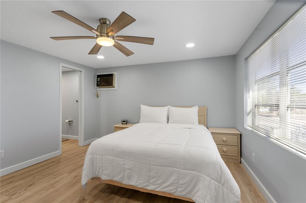 2476 North Beach Road Englewood, FL 34223 - Photo 39 of 58 a bedroom with a large bed and a large window