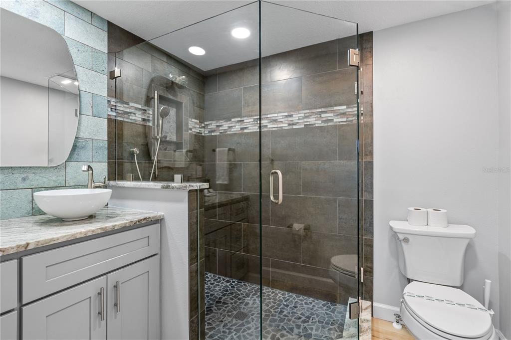 2476 North Beach Road Englewood, FL 34223 - Photo 41 of 58 a bathroom with a granite countertop sink toilet and shower