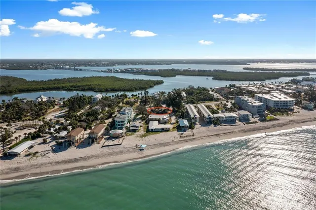 a kitchen with stainless steel appliances kitchen island granite countertop a table chairs stove and refrigerator