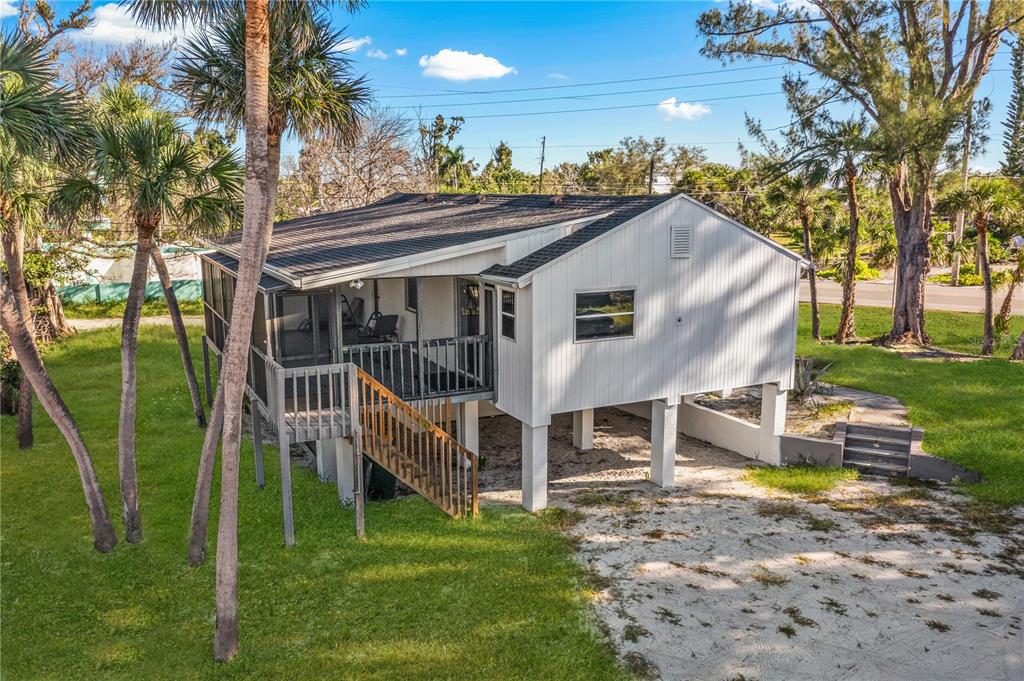 2476 North Beach Road Englewood, FL 34223 - Photo 52 of 58 a view of a house with a yard