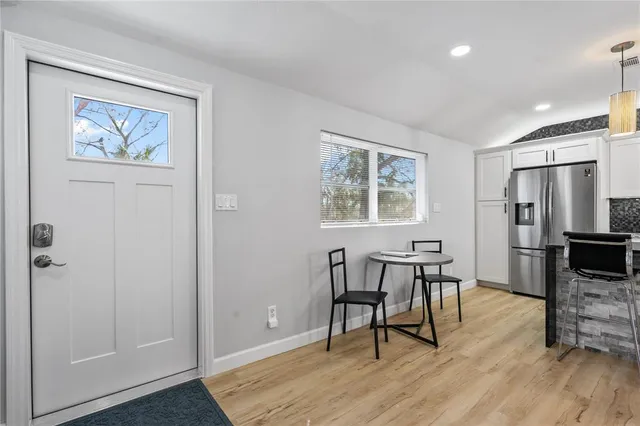 a living room kitchen with furniture and kitchen view