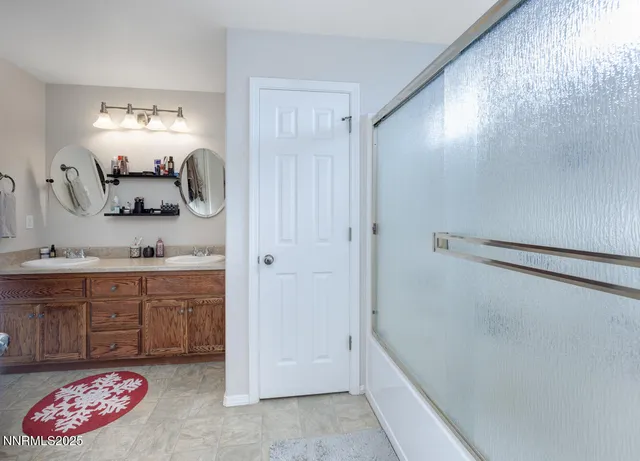 a bathroom with a granite countertop sink mirror and shower