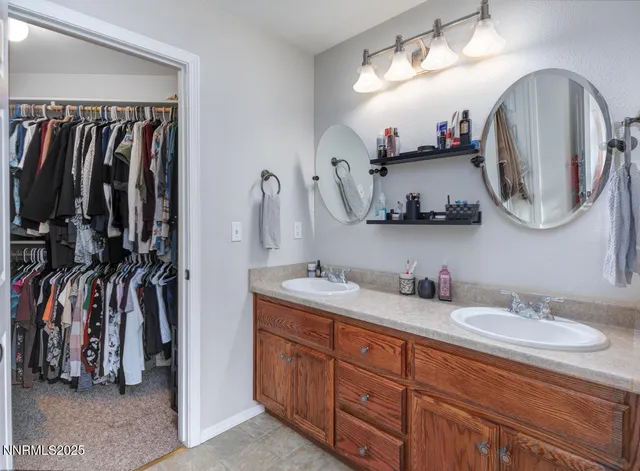 a bathroom with a double vanity sink and a mirror
