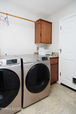 a utility room with sink dryer and washer
