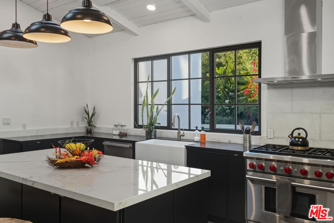 13019 Sky Valley Road Los Angeles, CA 90049 - Photo 18 of 39 a kitchen with a sink and a stove