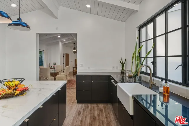 a kitchen with a stove a sink and a refrigerator