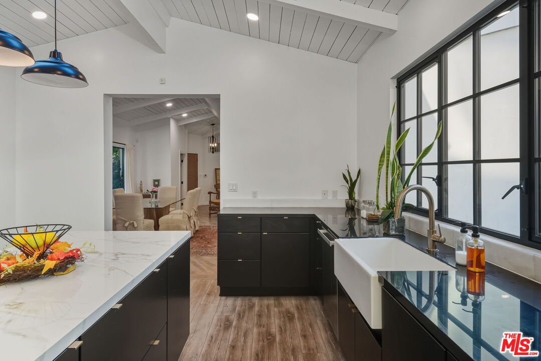 13019 Sky Valley Road Los Angeles, CA 90049 - Photo 19 of 39 a spacious bathroom with a double vanity sink and a large mirror