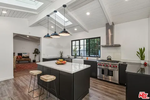 a kitchen with a sink and refrigerator