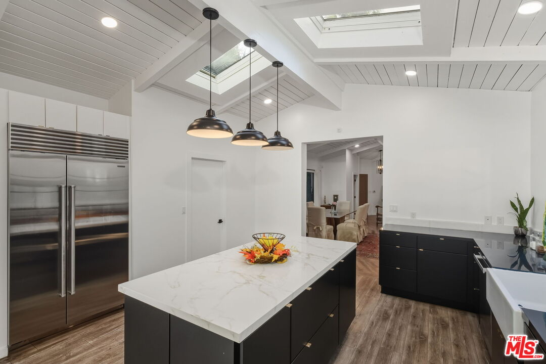 13019 Sky Valley Road Los Angeles, CA 90049 - Photo 21 of 39 a kitchen with a sink and refrigerator