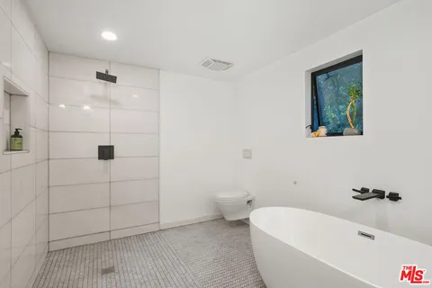 a bathroom with a bathtub and a shower