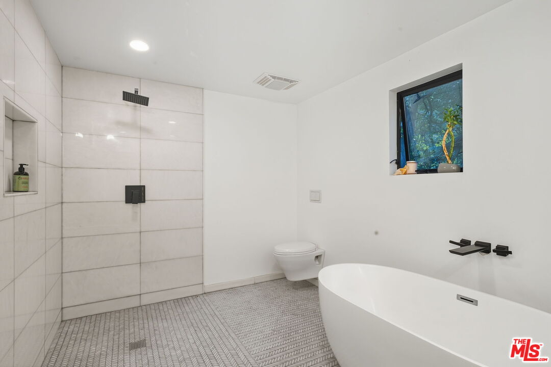 13019 Sky Valley Road Los Angeles, CA 90049 - Photo 27 of 39 a bathroom with a bathtub and shower