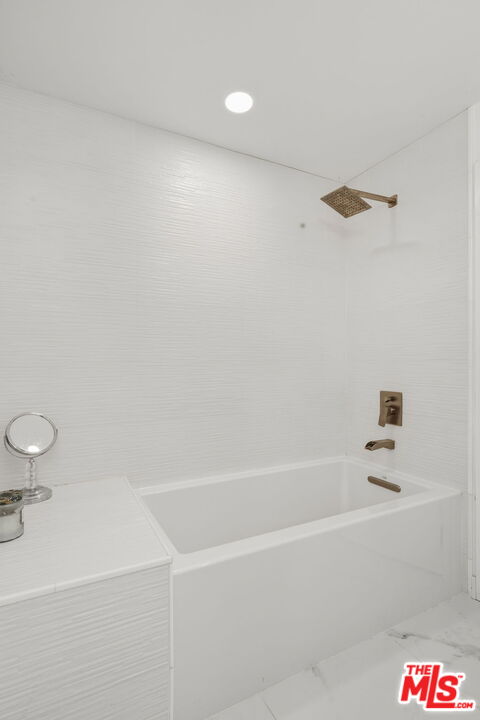 13019 Sky Valley Road Los Angeles, CA 90049 - Photo 28 of 39 a bathroom with a bathtub and a shower