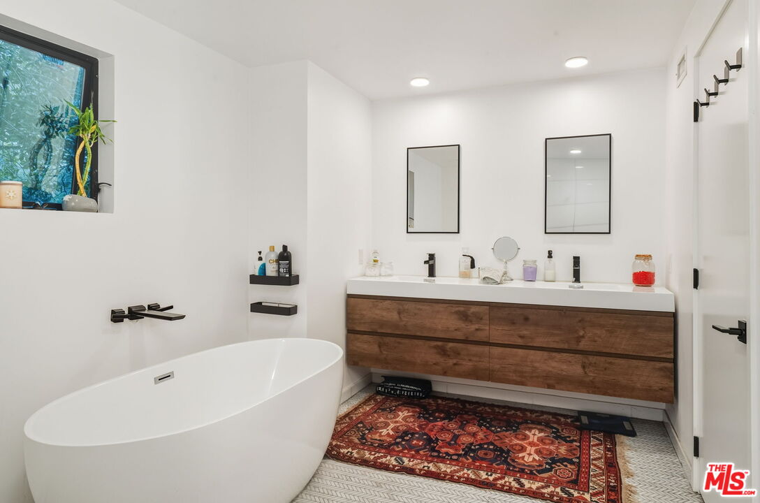 13019 Sky Valley Road Los Angeles, CA 90049 - Photo 30 of 39 a bathroom with a bathtub and a sink