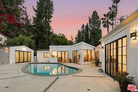 a view of a house with sitting area and garden