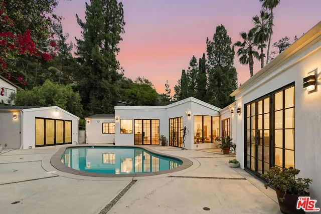 a view of a house with sitting area and garden