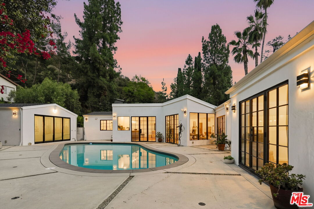 13019 Sky Valley Road Los Angeles, CA 90049 - Photo 31 of 39 a view of swimming pool and dinning table and chairs