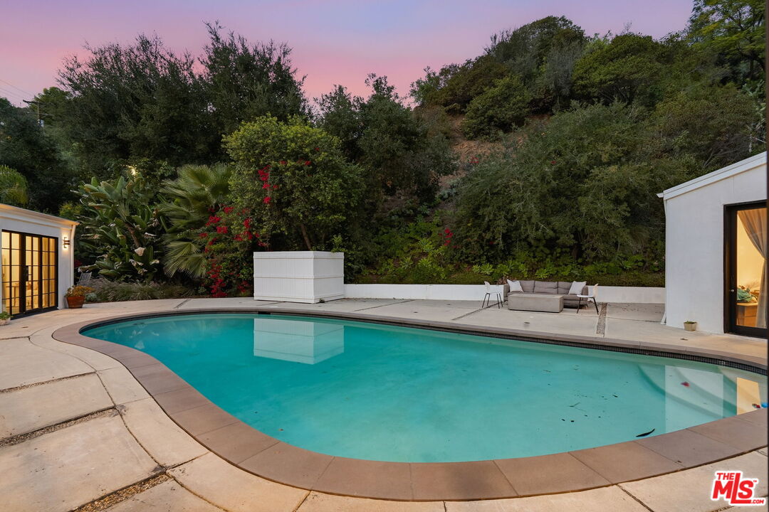 13019 Sky Valley Road Los Angeles, CA 90049 - Photo 34 of 39 a view of a swimming pool with a yard