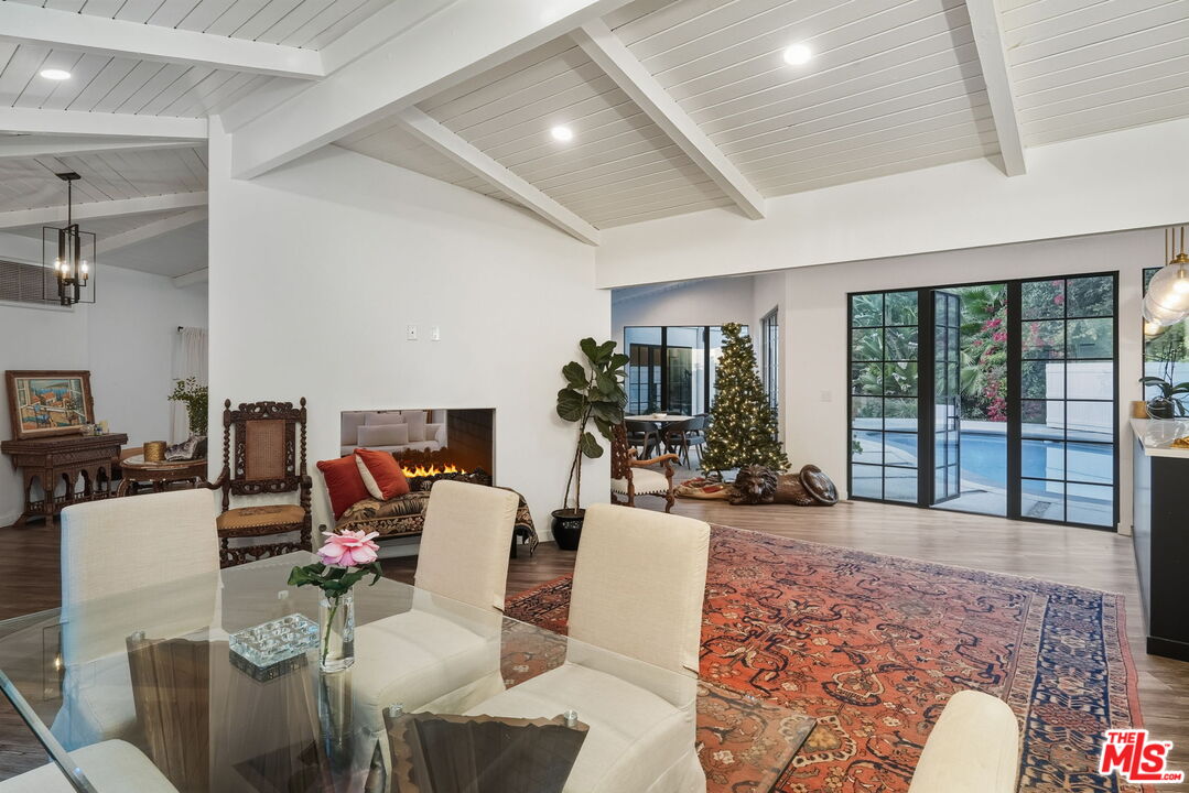 13019 Sky Valley Road Los Angeles, CA 90049 - Photo 6 of 39 a living room with furniture large window and wooden floor