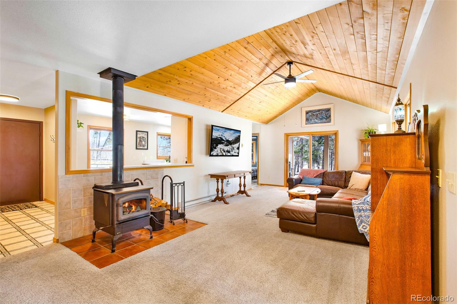 757 Thompson Park Road Fairplay, CO 80440 - Photo 2 of 49 a living room with furniture a flat screen tv and a table