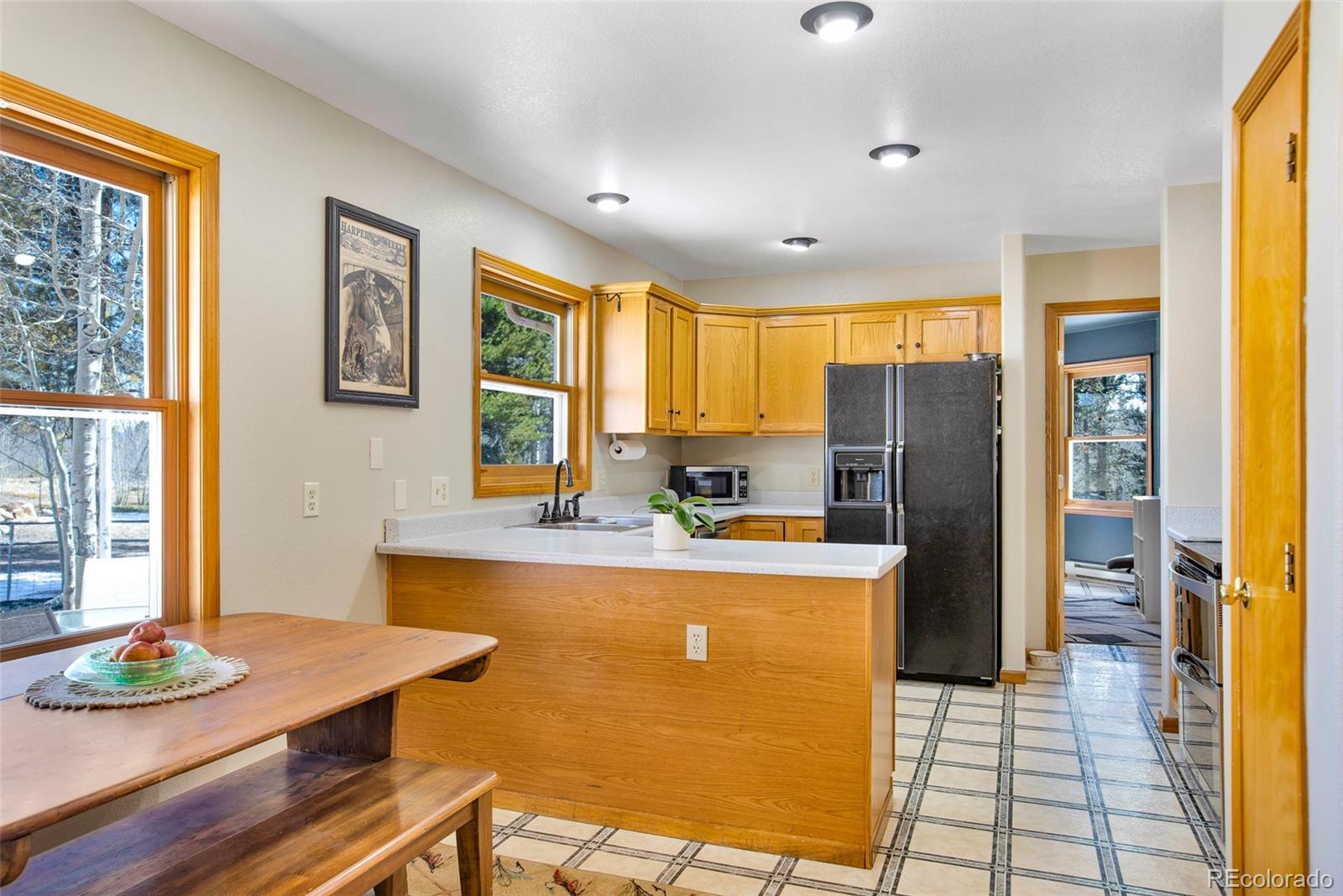 757 Thompson Park Road Fairplay, CO 80440 - Photo 28 of 49 a view of a kitchen with kitchen island a large window cabinets a sink and stainless steel appliances
