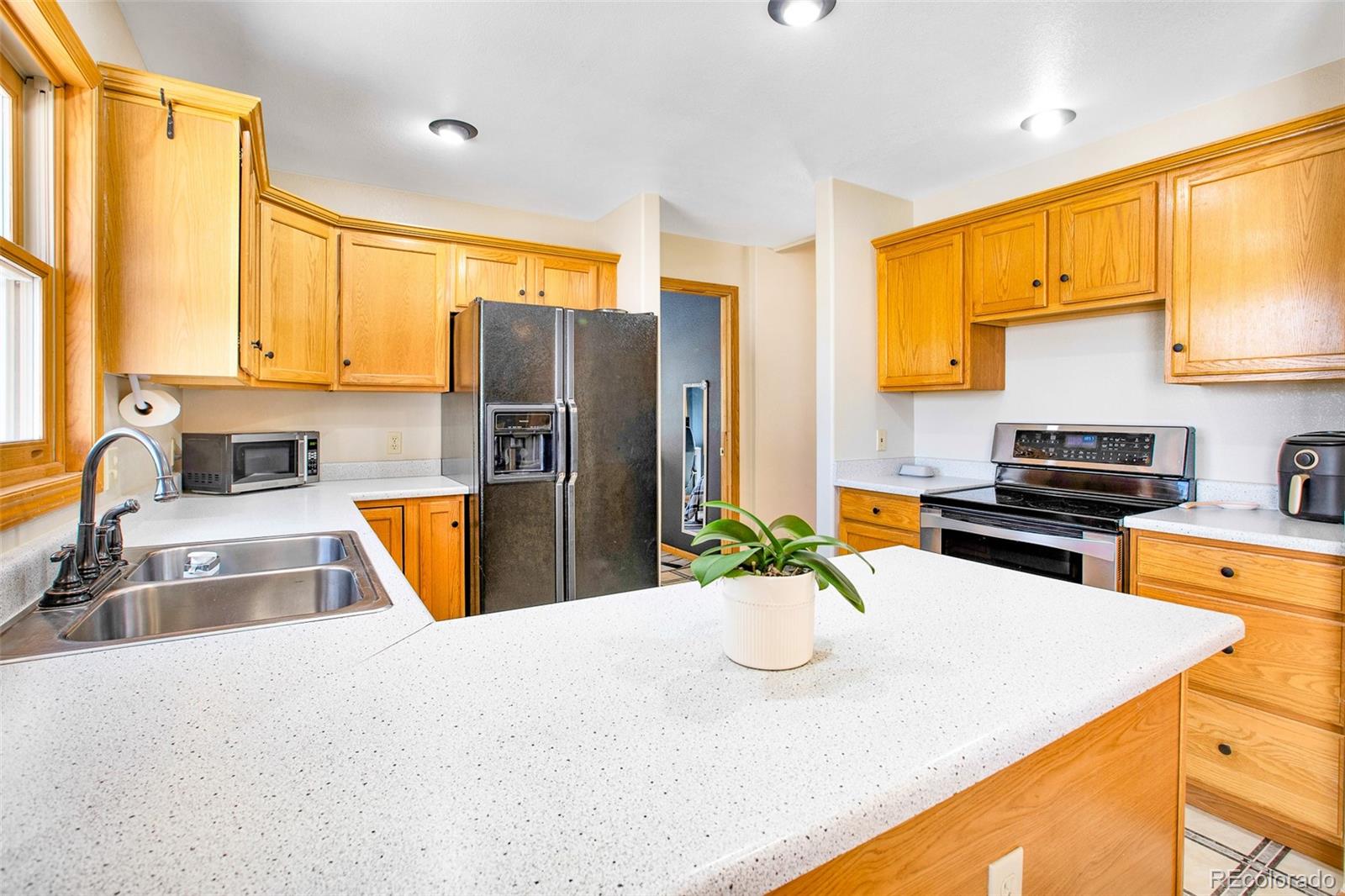 757 Thompson Park Road Fairplay, CO 80440 - Photo 29 of 49 a kitchen with stainless steel appliances granite countertop a sink a stove and a refrigerator