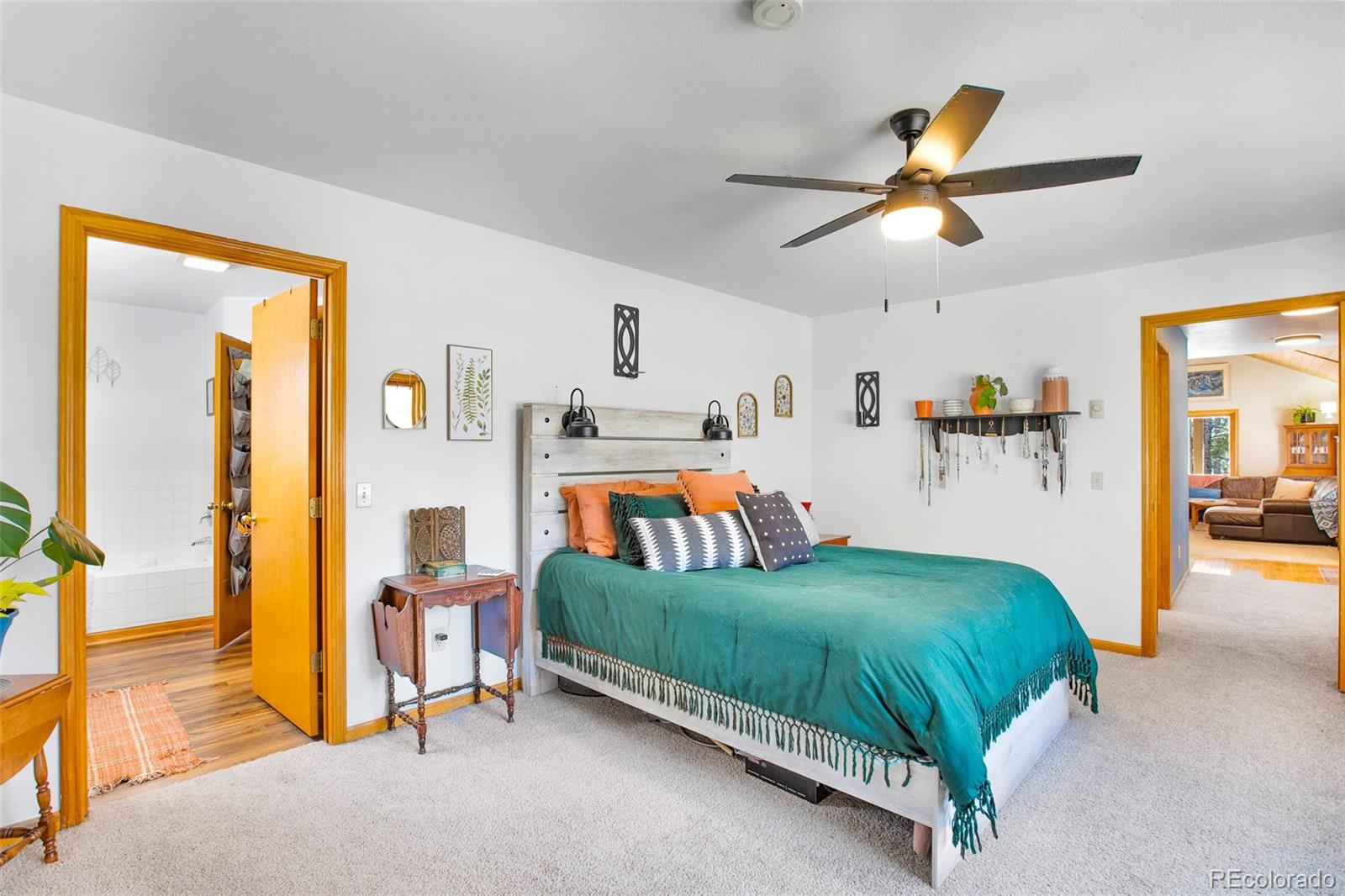 757 Thompson Park Road Fairplay, CO 80440 - Photo 9 of 49 a bedroom with a bed and a chandelier