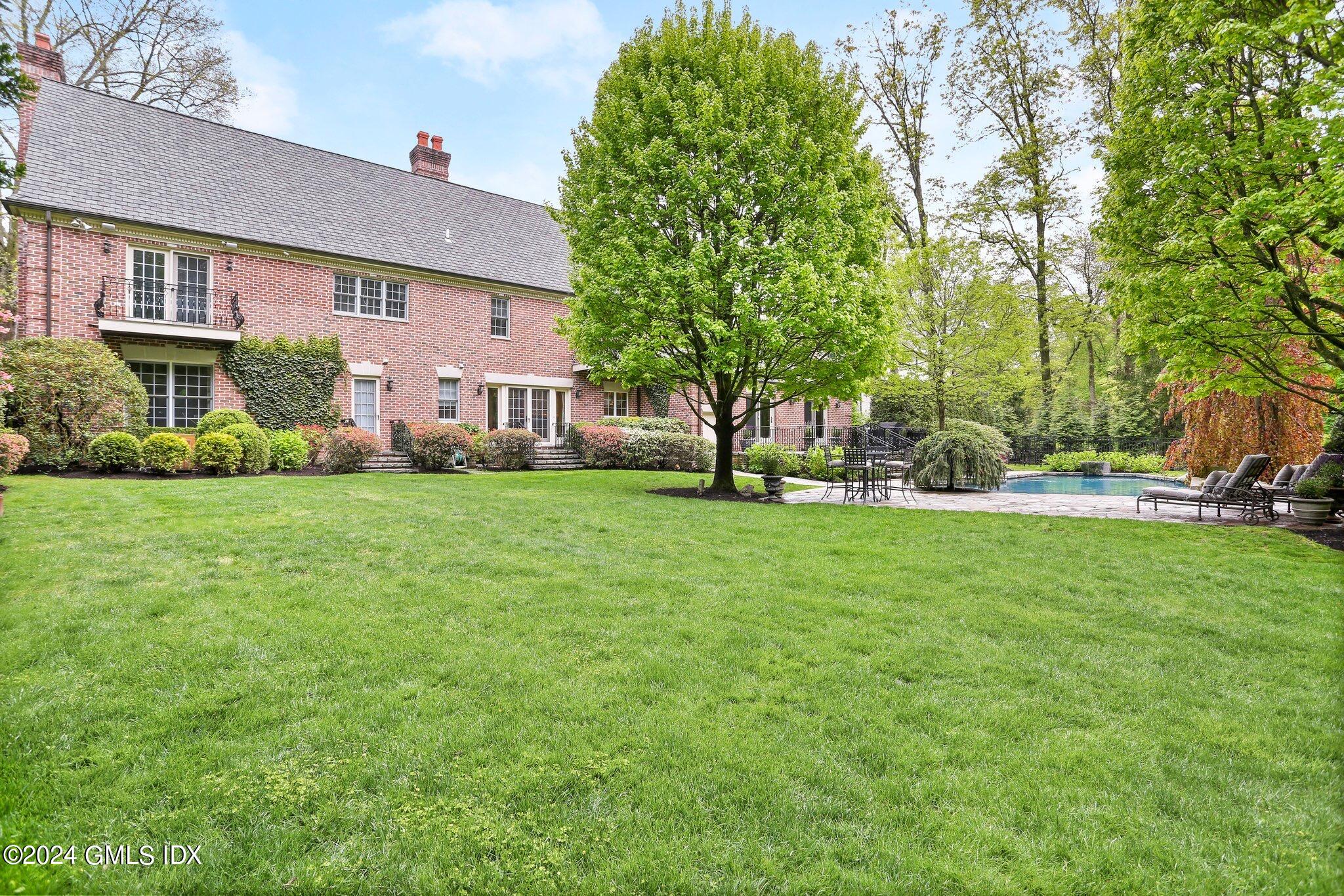 376 Westover Road Stamford, CT 06902 - Photo 37 of 37 a view of a house next to a big yard and large trees