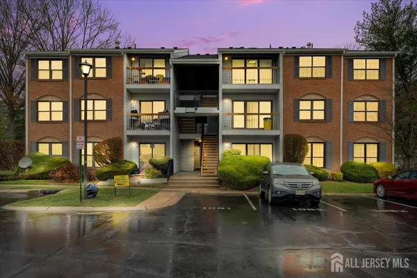 a front view of a residential apartment building with a yard