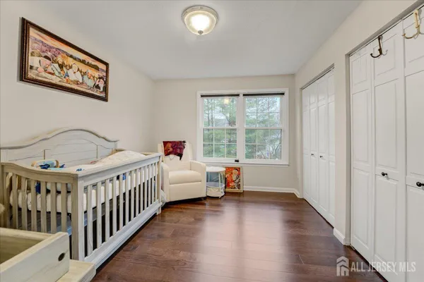 a view of a bedroom with wooden floor