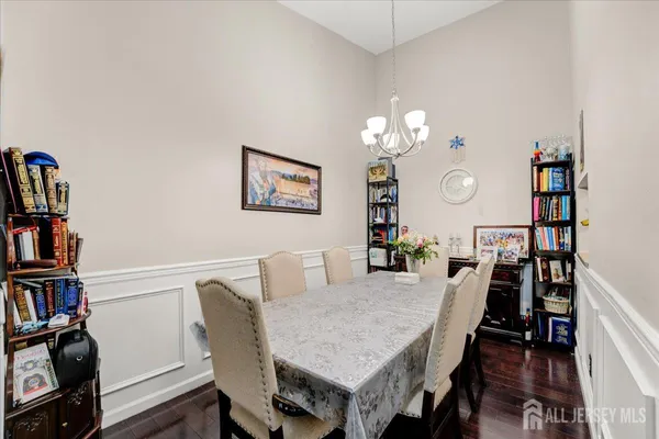 a view of a dining room with furniture and a book shelf