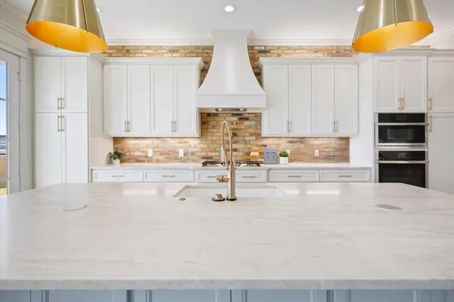 a kitchen with stainless steel appliances a stove a sink and a refrigerator