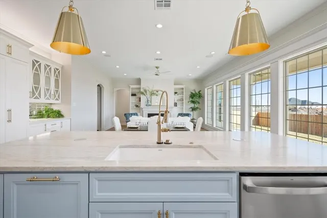 a view of living room with a table and a chandelier