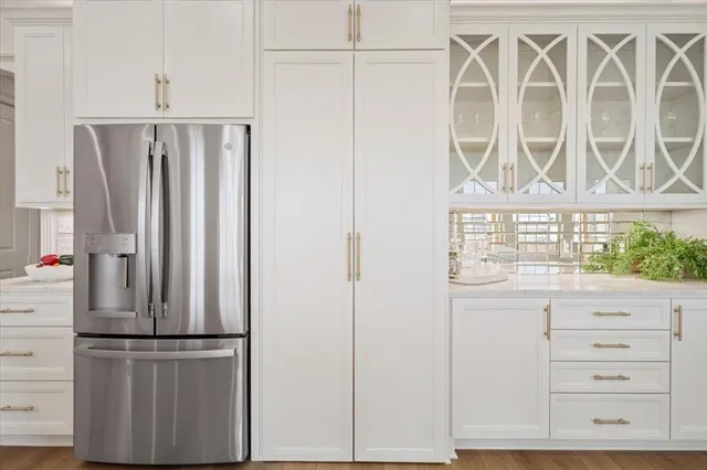a kitchen with a refrigerator and cabinets
