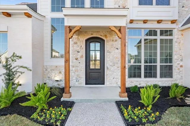 a front view of a house with potted plants