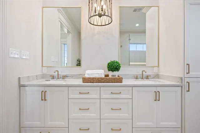 a bathroom with a granite countertop sink a toilet and shower