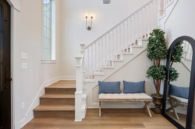 a view of staircase with lots of frames and flower garden