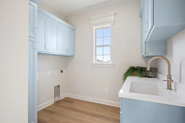 an empty room with windows and chandelier fan