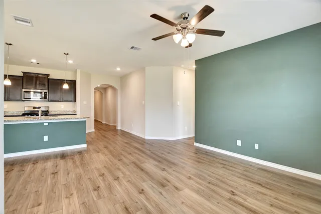 a view of kitchen with stainless steel appliances granite countertop a refrigerator a sink dishwasher and a stove