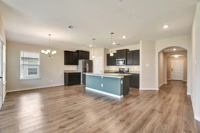 a view of kitchen with refrigerator microwave and wooden floor