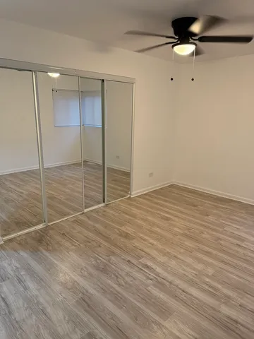 a view of an empty room with a ceiling fan