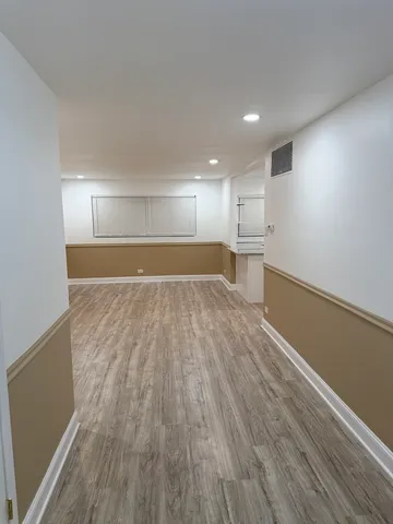 a view of a kitchen with a sink and wooden floor