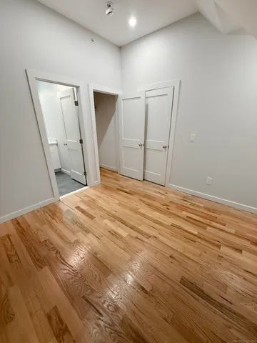 a bedroom with a bed and a mirror