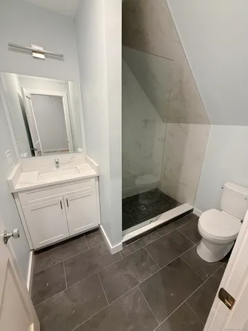 a bathroom with a sink toilet and mirror